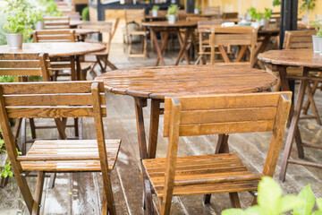 Empty tables on the terrace in a cafe after the rain - 445636234