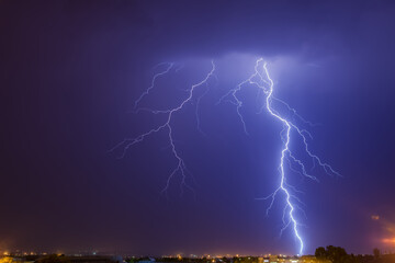 Naklejka premium Cloud to ground bright lightning strike over Johannesburg at nighttime