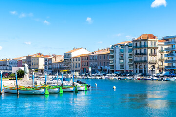 Sète in France, traditional boats moored at the quay in the city centre
