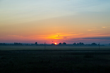 Calm beautiful sunrise over a rural field