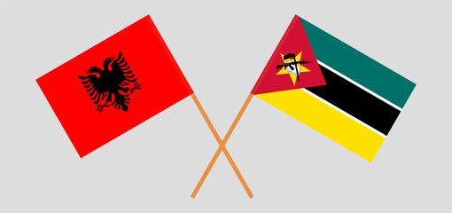 Crossed flags of Albania and Mozambique. Official colors. Correct proportion