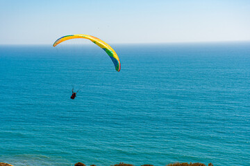 Paragliders with the beautiful blue open ocean, waves, and water behind them. Location near blacks...