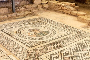 Cyprus, Limassol - 29 June 2021. Floor mosaic in the house of Eustolios in the ancient city of Kourion. The image shows the goddess of construction Ktisis, holding an architect's ruler.