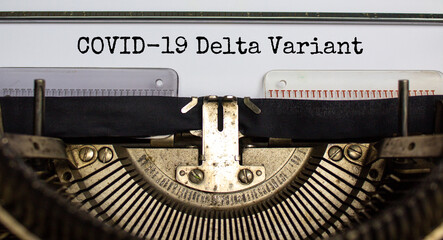 Covid-19 delta virus variant symbol. Words 'Covid-19 delta variant' typed on retro typewriter. Medical and COVID-19 new delta plus variant concept.