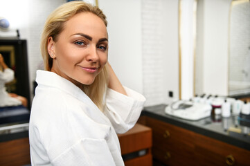 Close-up portrait of the face of beautiful smiling woman in spa clinic.