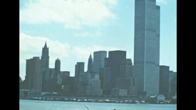 Archival of Manhattan skyline, sea view from Hudson river sightseeing cruise. Old Twin Towers skyscrapers and office buildings of New York city. United States America in 1976.
