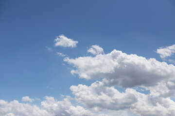 Blue sky with cumulus clouds.