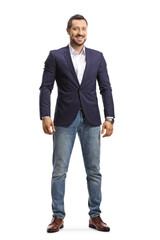 Full length portrait of a man in jeans and suit standing and smiling