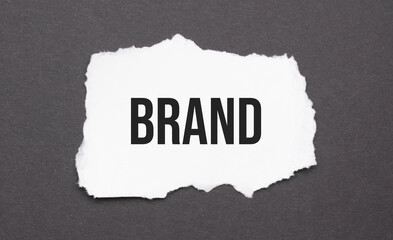 brand sign on the torn paper on the black background