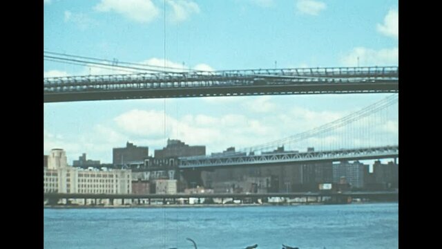 Archival of Brooklyn Bridge in New York city. Cityscape from a boat tour on East river of Manhattan Upper Bay of New York City in 1976. Archival of Manhattan skyline. close up view