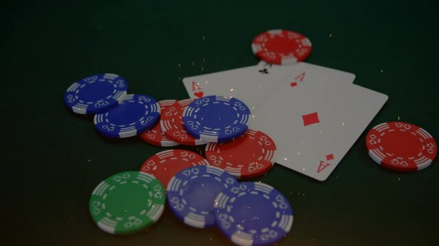 Animation of confetti and poker chips falling onto playing cards on gambling table