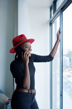 Woman in red hat having a phone conversation