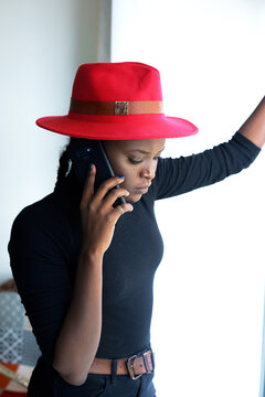 Woman in red hat having a phone conversation
