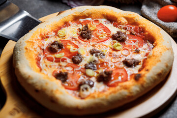 Pizza with bacon, tomatoes, cheese and olives. Italian Cuisine.