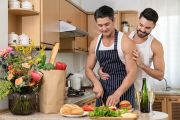 Affectionate gay couple enjoy cooking at kitchen together