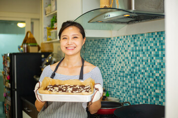 Chinese woman holding fresh brownies chocolate