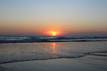 Colorful sunset on the shore of the ocean