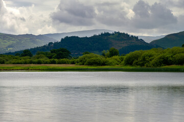 Fototapeta na wymiar View of Bassenthwaite Lake surrounded by hills on a cloudy summer afternoon, Lake district, England