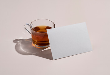 Fototapeta na wymiar Stationery mockup. Plain greeting cards, invitations, and warm tea on a beige background.