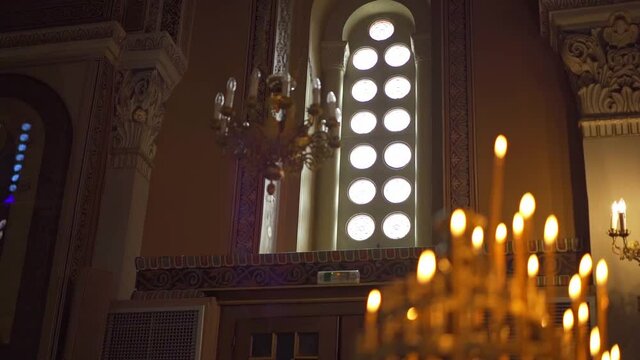 Closeup of burning candles in a luxury catholic church in Greece
