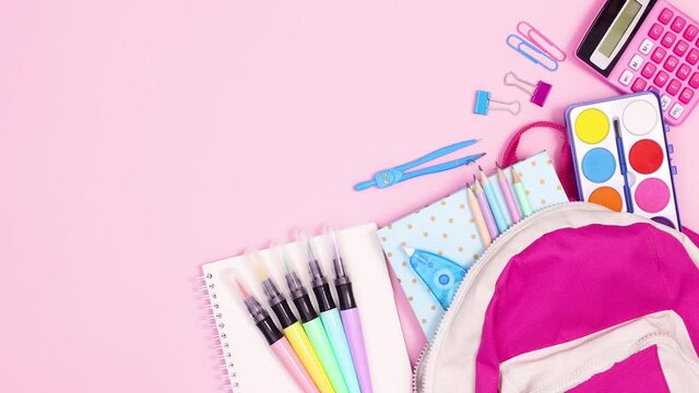 Moving school stationery with backpack on pink theme. Stop motion