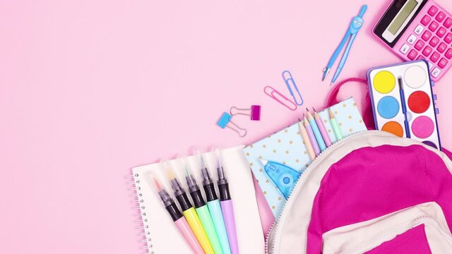 Back to school tools come out of backpack on pink theme. Stop motion