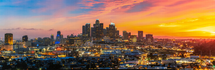 Panoramic shot of a beautiful bright Los Angeles city in California under an orange sunset sky