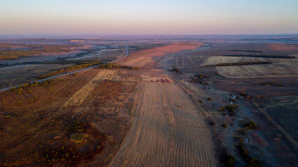View from above. Endless plowed fields in autumn. Waste agricultural fields.