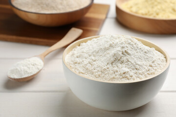 Bowl of flour on white wooden table
