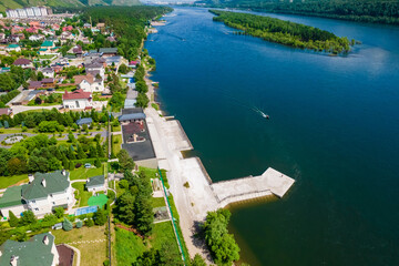 Naklejka premium cottage village on the river bank