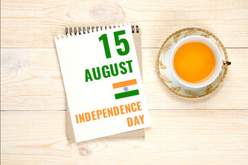 15 august indian independence day, calendar paper sheet with tea cup on aged wooden table