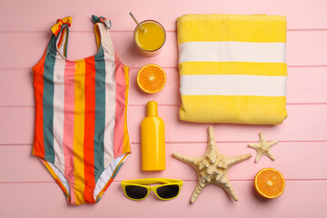 Flat lay composition with beach objects on pink wooden background