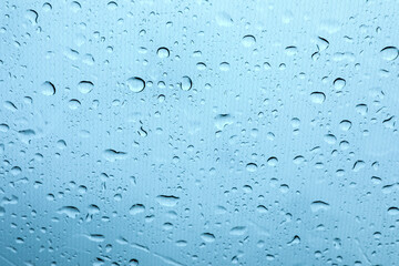 Window glass with water drops, closeup view