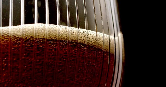 Pouring red ale beer into glass close up 