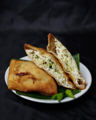 Mini martabak isolated on black background. Martabak is a typical Indian food called Mooraba. This egg martabak is very popular in Indonesia to be used as an evening snack. Focus blur.
