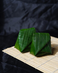 Green sticky rice tapai isolated on a black background. Tapai is a culinary product that is produced through a fermentation process. Tapai sticky rice is a typical Indonesian food, precisely from Cibe