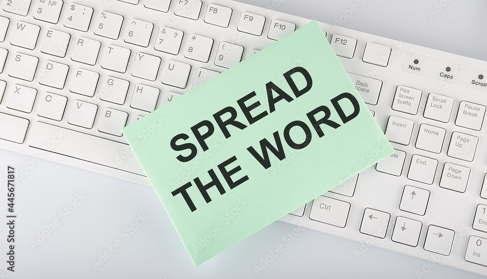 Poster text spread the word on envelope on keyboard on the white background