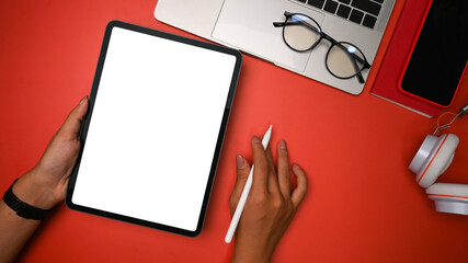 Overhead shot creative woman holding stylus pen and digital tablet.