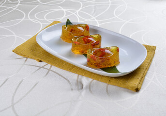 chinese dessert cold jelly with herb gui Hua flower yellow pudding in yuan bao money shape asian...