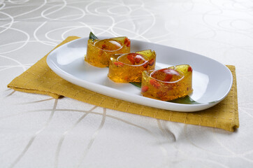 chinese dessert cold jelly with herb gui Hua flower yellow pudding in yuan bao money shape asian banquet halal menu