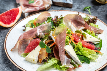 Salad with prosciutto, grapefruit, salad mix, cherry tomatoes, brie cheese. Healthy fats, clean eating for weight loss