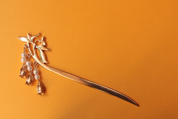 Chinese hairpin hair clips on a illuminated golgen yellow background. Chinese traditional jewelry.