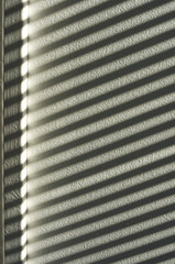 Close-up of light and shadow in black and white on a stair step, like comb teeth