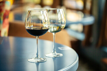 Two glasses of red and white wine on the blue restaurant table