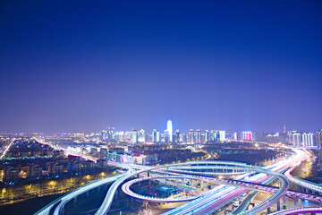 Aerial shot of the city’s night view of Henan, China, beautiful highway overpasses and skyscrapers