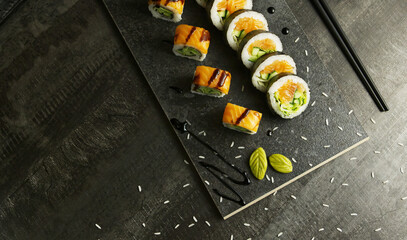 Close up of salmon sushi on a black wooden board, Japanese cuisine