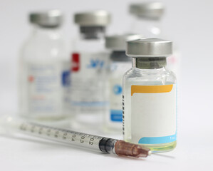 vaccine and syringe on white background with copy space for text