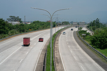 Bandung, Indonesia - June 30, 2021: Situation of the Soroja toll road at noon. It looks quieter than before, which is always crowded with vehicles.