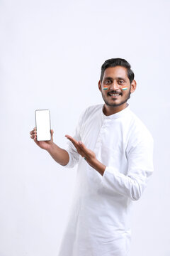 Young indian man celebrating independence day and showing smartphone.
