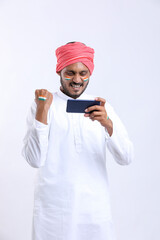 young indian man celebrating independence day or republic day and using smartphone.